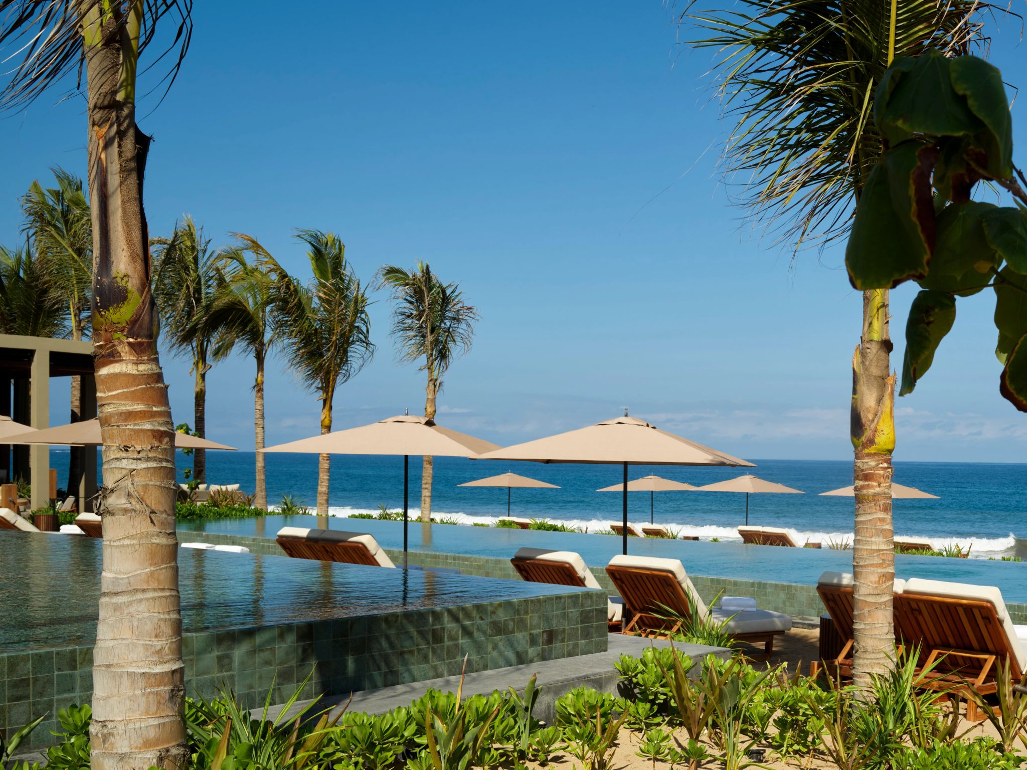 Praia e Piscina cabanas e guarda sois na praia-piscina e areia branca-rosewood mandarina